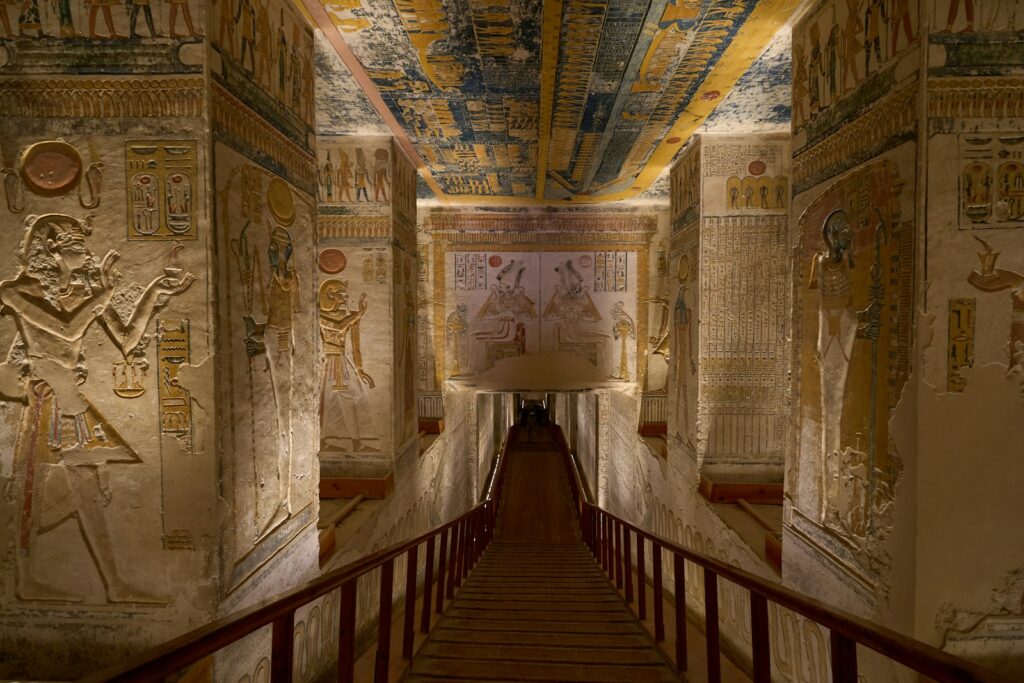The painted hypostyle hall of an Upper Egyptian temple, evoking the celestial ceiling at Dendera